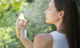 woman spraying mist on herself