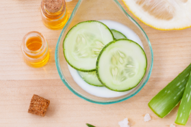 bowl of cucmbers next to a vial